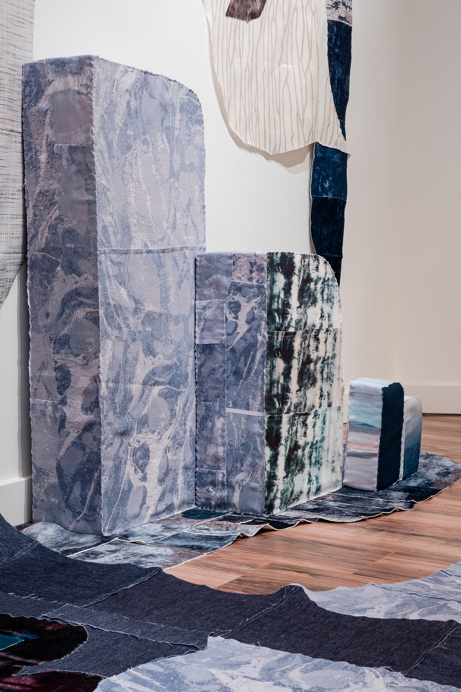 7 Worlds (Detail), 2020, Three-dimensional applique with reclaimed fabric and upcycled foam inserts, Dimensions variable (pictured: 16 x 9 x 4 ft)