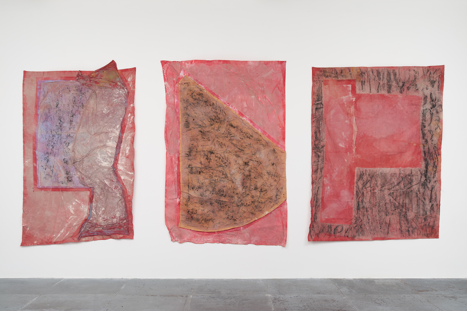 Oak - Zaytoun - Flintstone, 2022, charcoal rubbings made of different hard surfaces, dyes extracted from flowers discarded fabric, ash, each 1.7 x 1.4 m